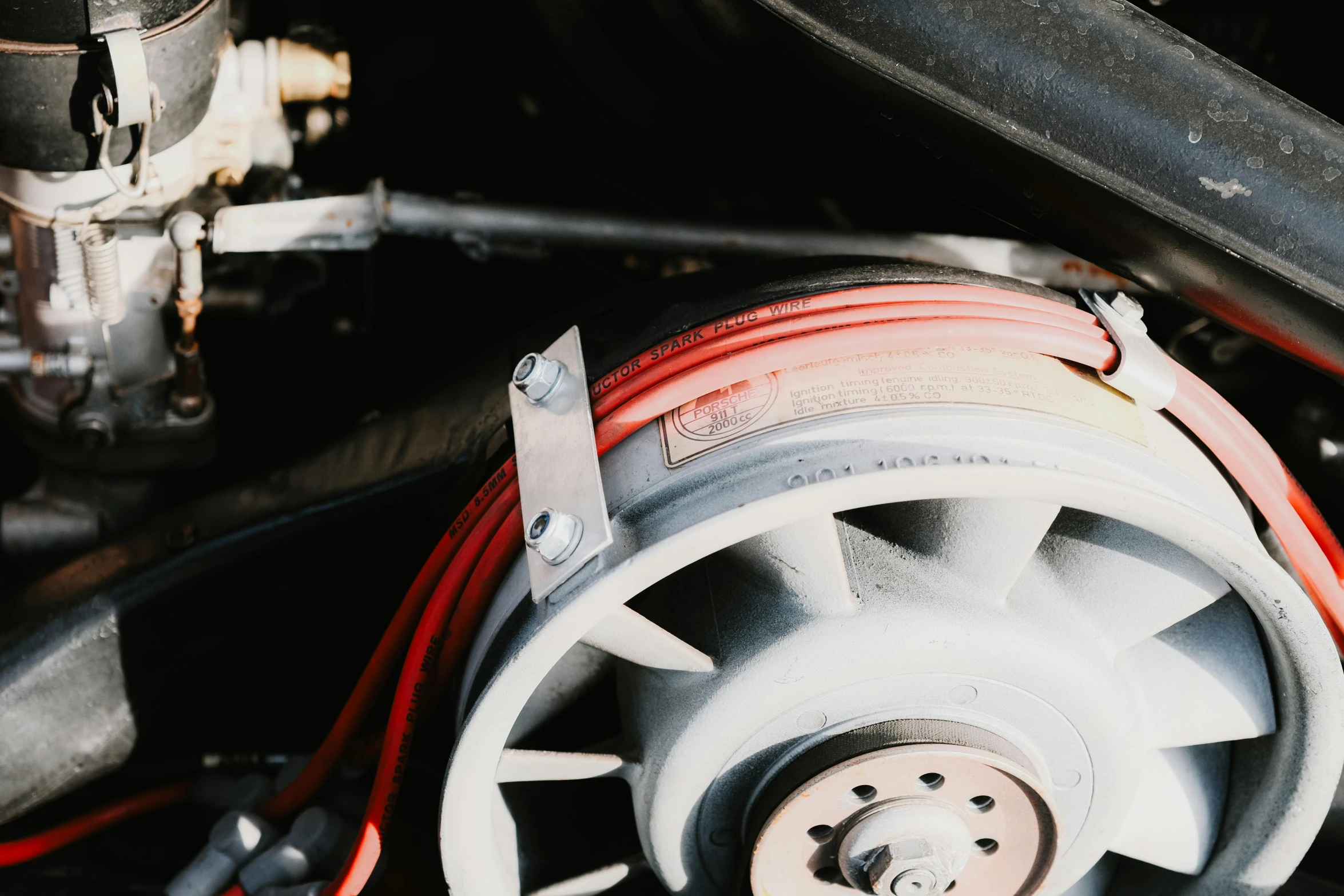 the white wheel on a vehicle's motor has red and black wires running around it