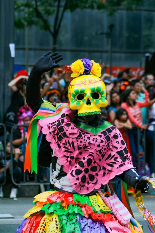 the brightly colored skeleton is wearing a colorful dress