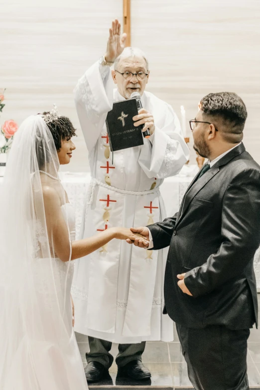 the bride and groom are exchanging the wedding rings