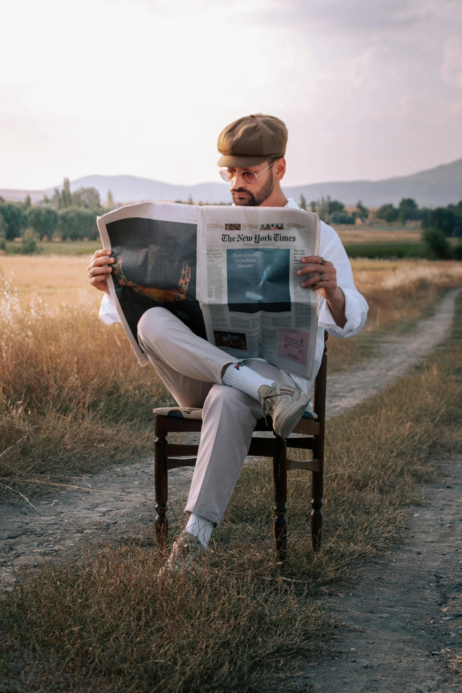 a man sitting on a chair with a newspaper in hand