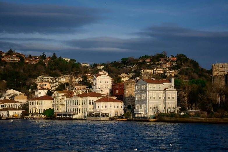 a hill side village on top of the water with a building