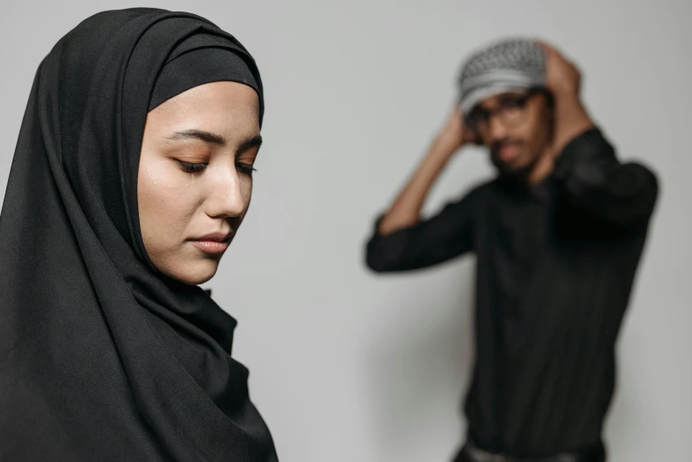 a woman in black is standing next to a man