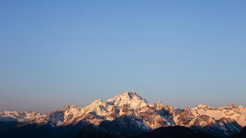 the view from a mountain top at sunset