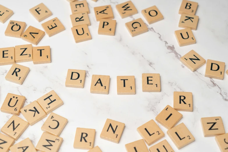 scrabbled tiles laid out on the surface with letters arranged next to them