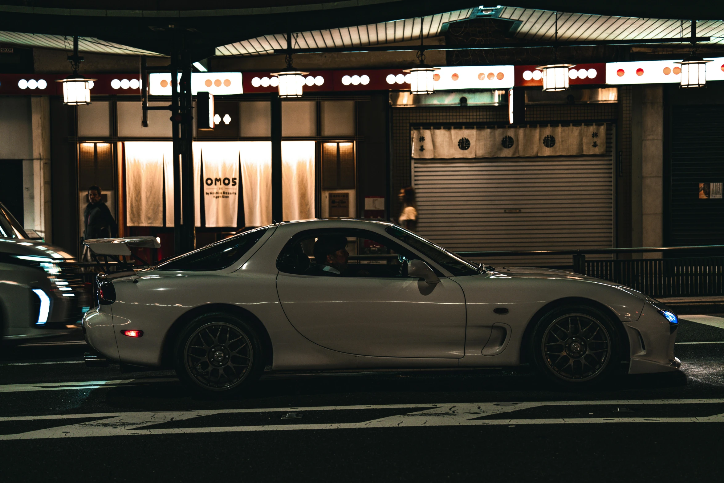 two cars on a city street at night