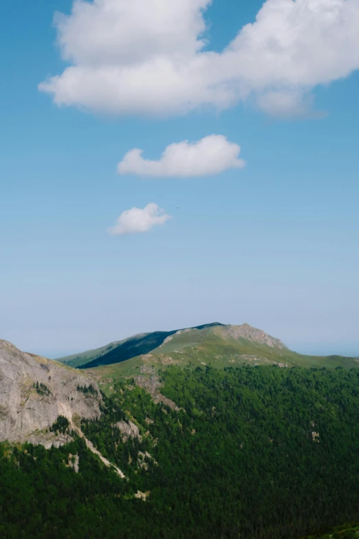 a view of some mountains from a high hill