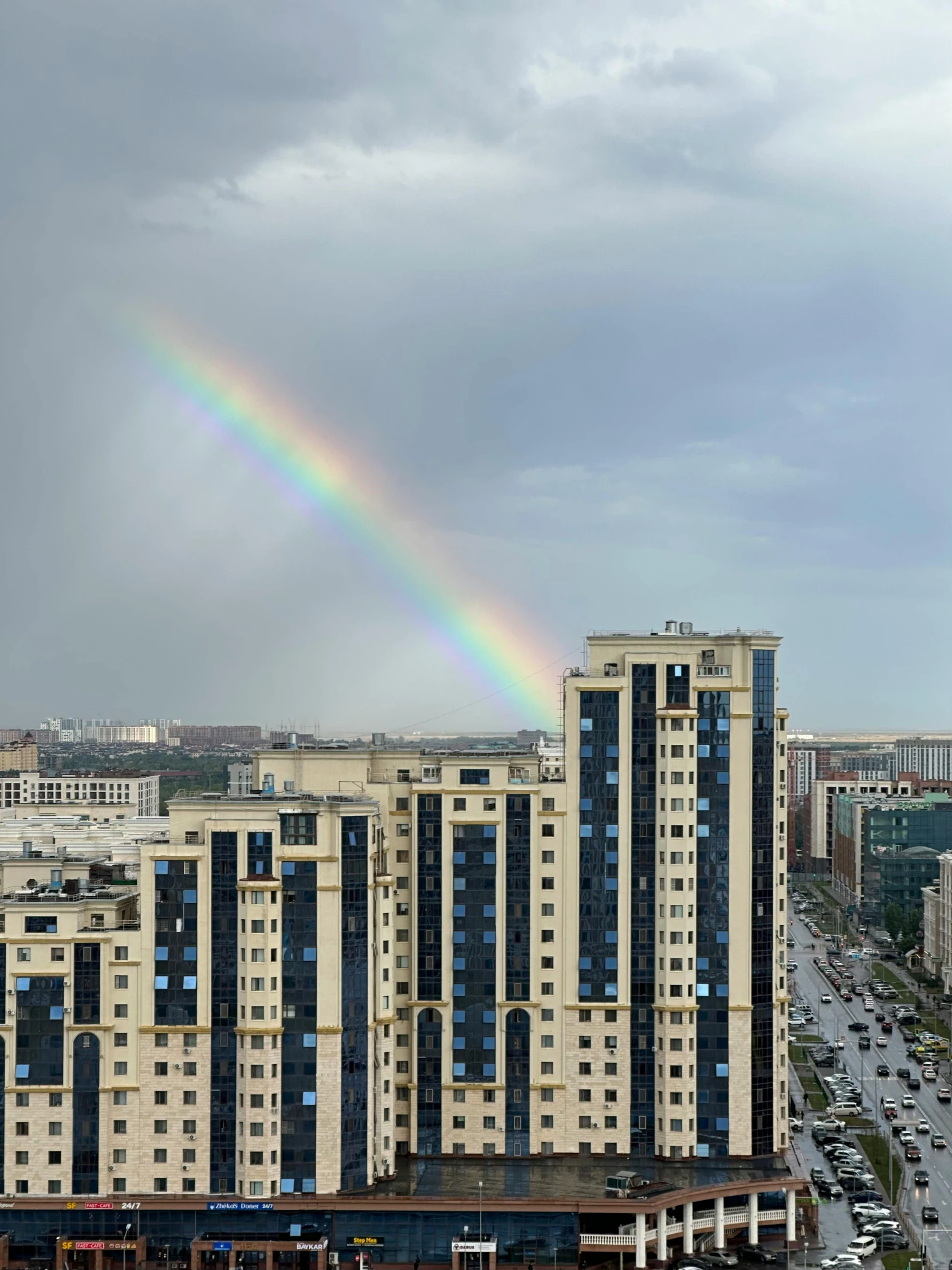 a rainbow is in the sky over the city