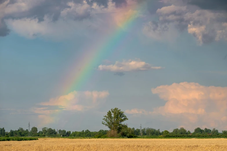 a rainbow with a very large amount of clouds