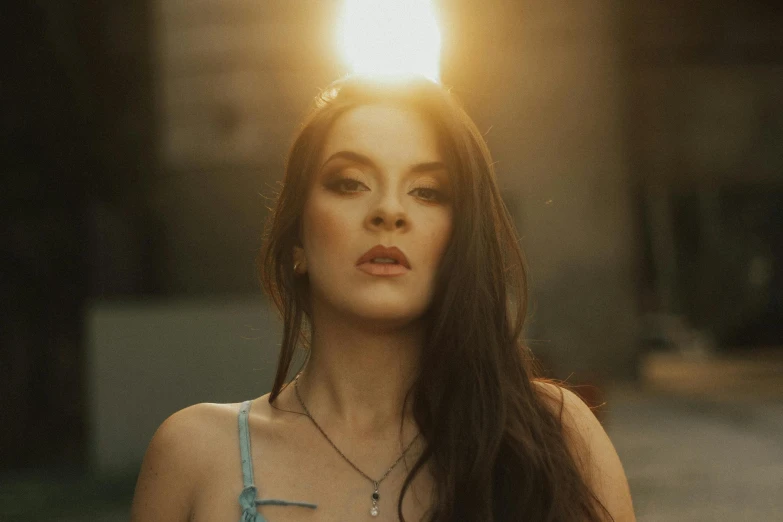 a woman with dark hair and a very large necklace