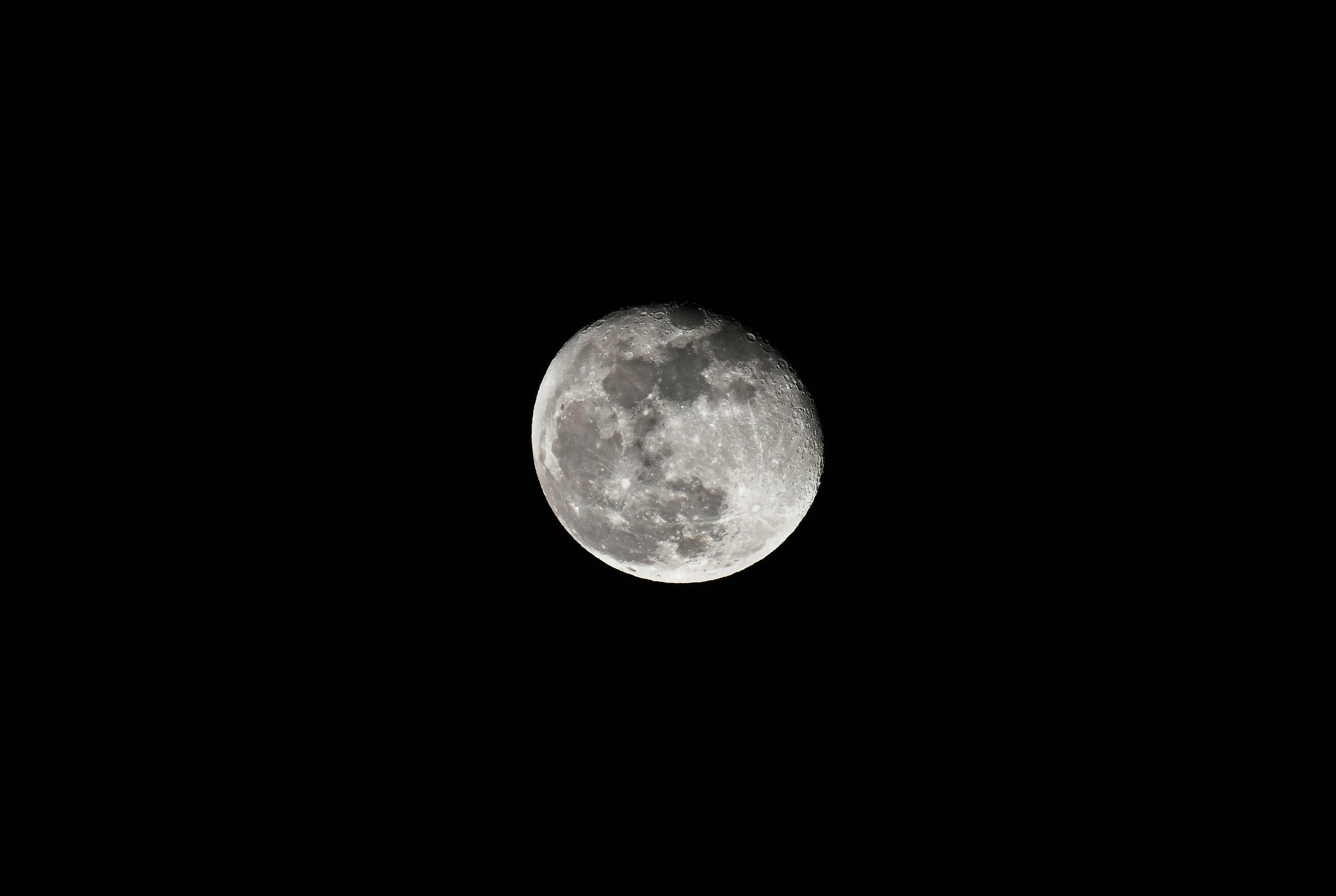 a full moon in the dark night sky