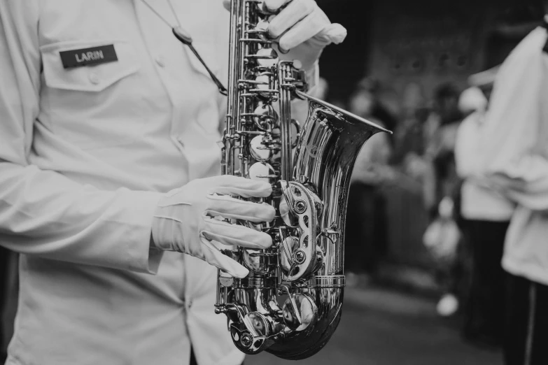 a man standing next to another person holding a saxophone