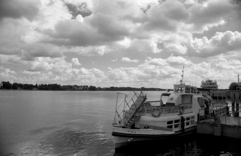 the ferry is docked on the large body of water