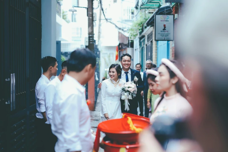 a bride and groom exiting the wedding ceremony with a crowd around