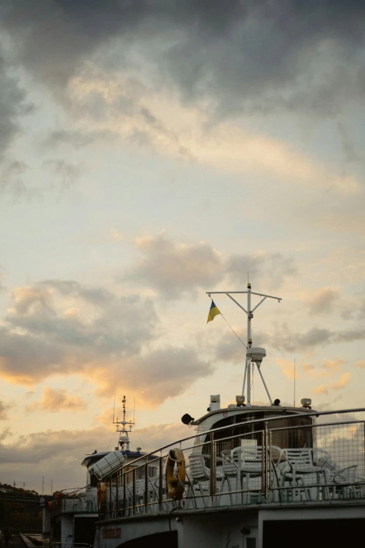 a large boat on the water with clouds in the sky