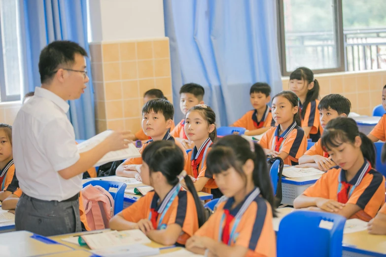 an instructor teaching a class at a elementary school