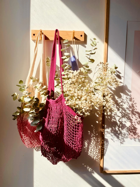 hanging purses with flowers on a wall