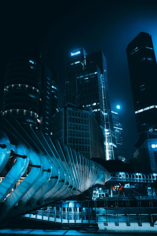 a night view of some buildings with some very tall skyscrs in the background