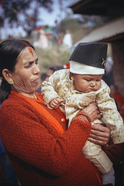 the woman is holding her baby up for a po