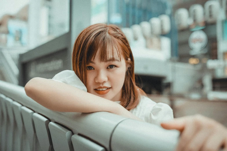 a young woman leaning on the rail in the city