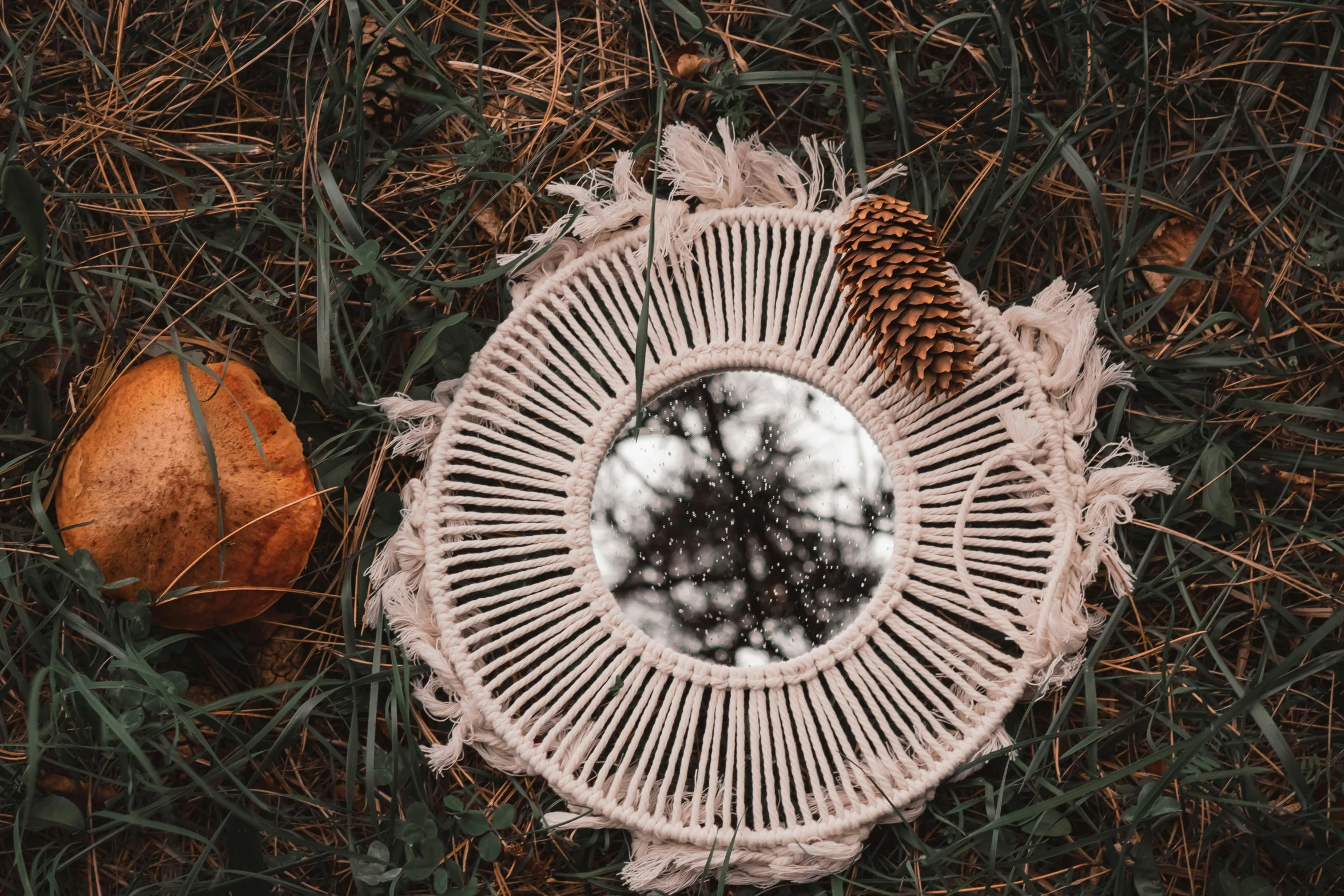 the woven wicker table cover looks like it has pine cones