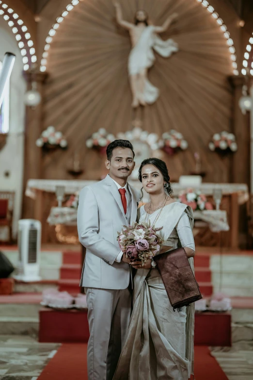 a bride and groom standing in front of the altar