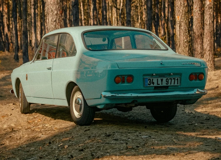 an old car in a wooded area with trees