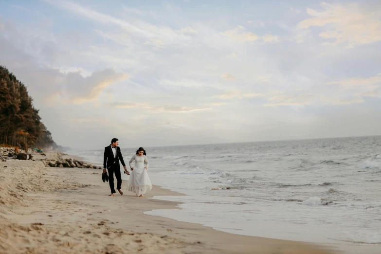 a man and a woman walking on the beach