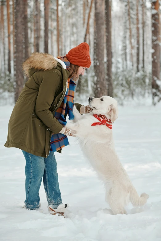 the woman is petting her dog as she holds his head up