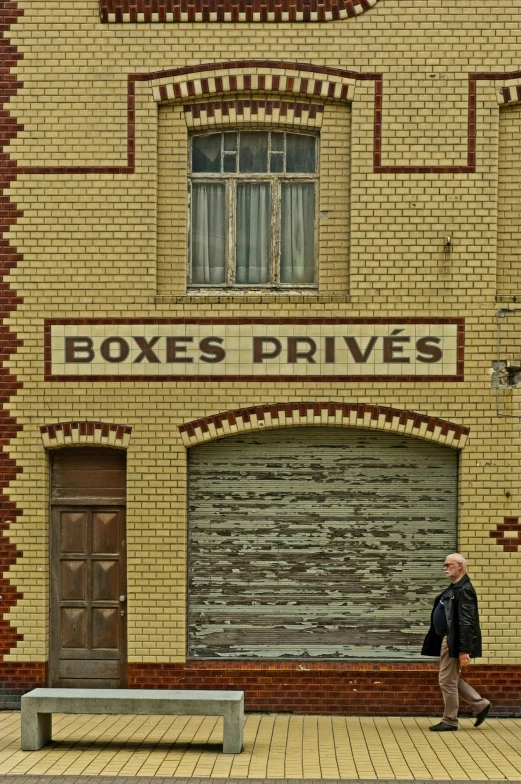 a person on a brick sidewalk next to a garage door