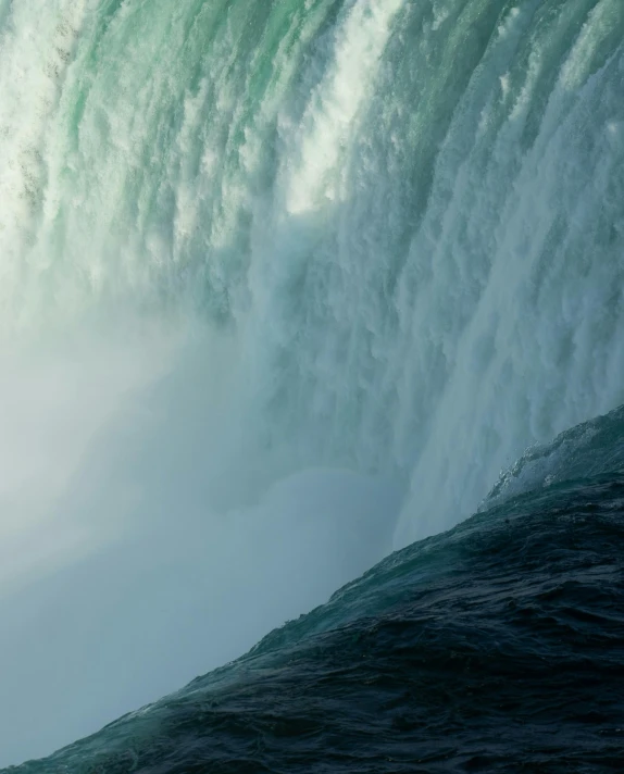 a view of the waterfall with surfers riding on waves