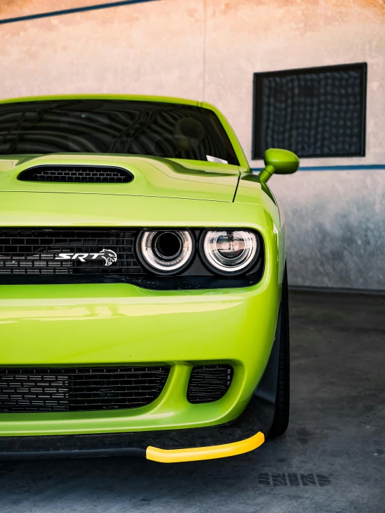 a green sports car with headlight lights