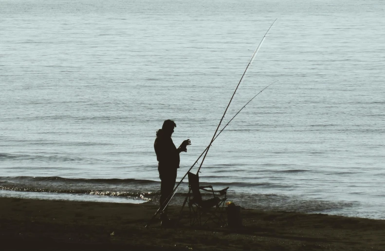 a person fishing from the ocean by itself