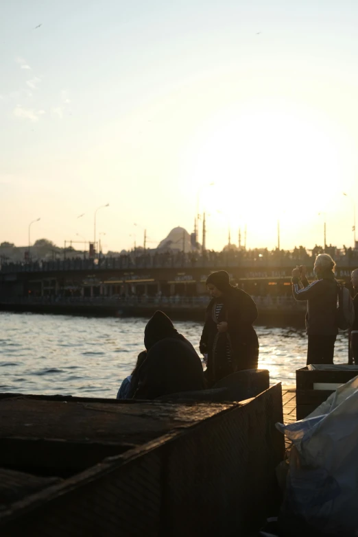 people are gathered near a large body of water