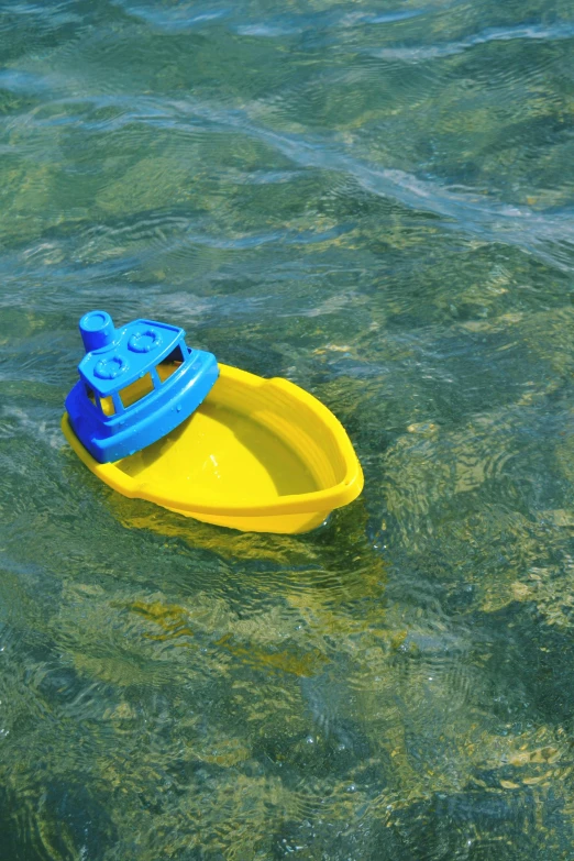 small toy boat in open blue water