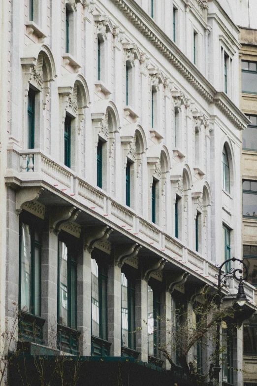 an old building with windows, railing and wrought iron handrails