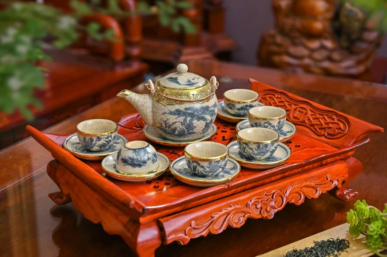 tea set on a red tray, with oriental writing