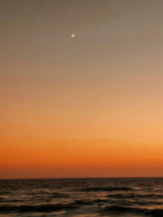 a plane is flying in the air with some orange sky above it