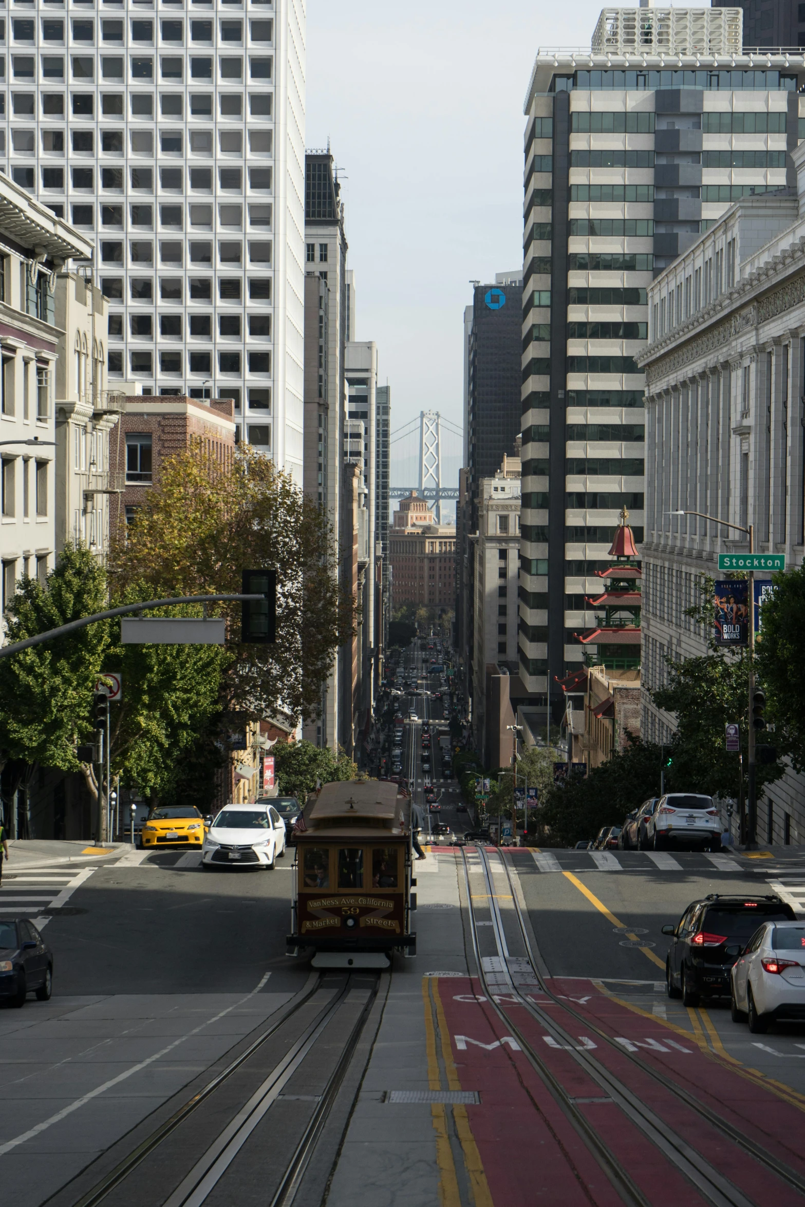 a city street with a trolley car moving on the track