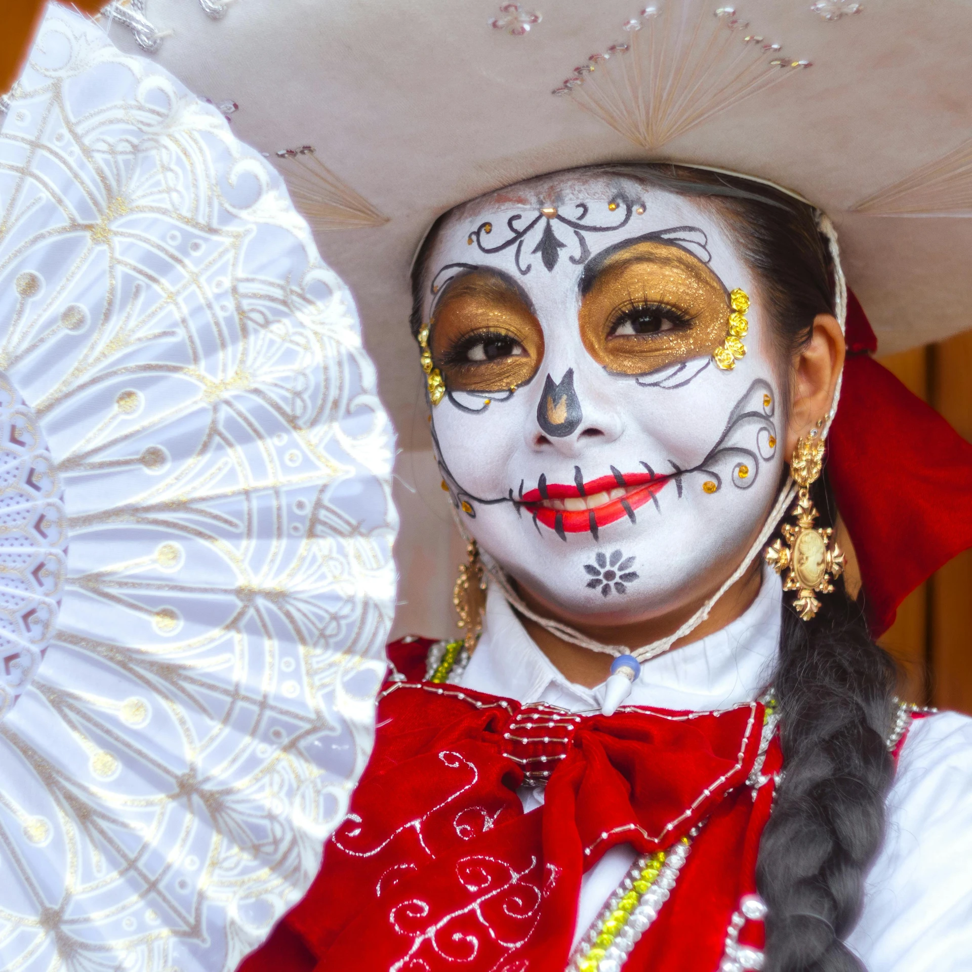 a person with white makeup and a white mask