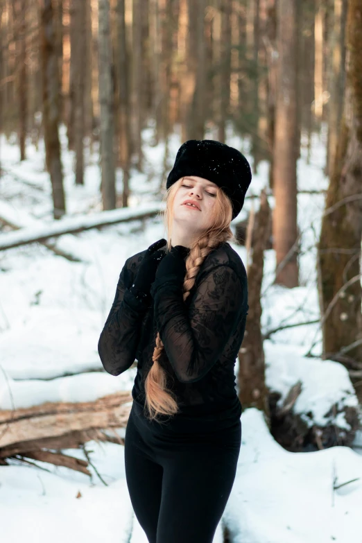 a woman in the woods with her hands on her face