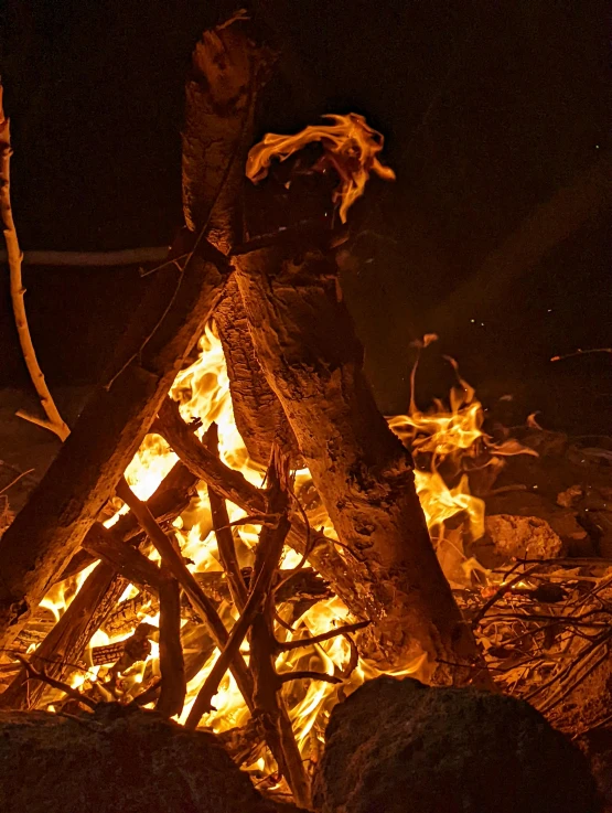 a person that is standing in front of fire