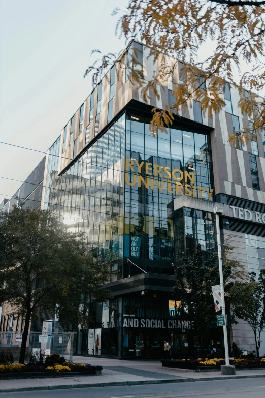 a glass office building in front of a street