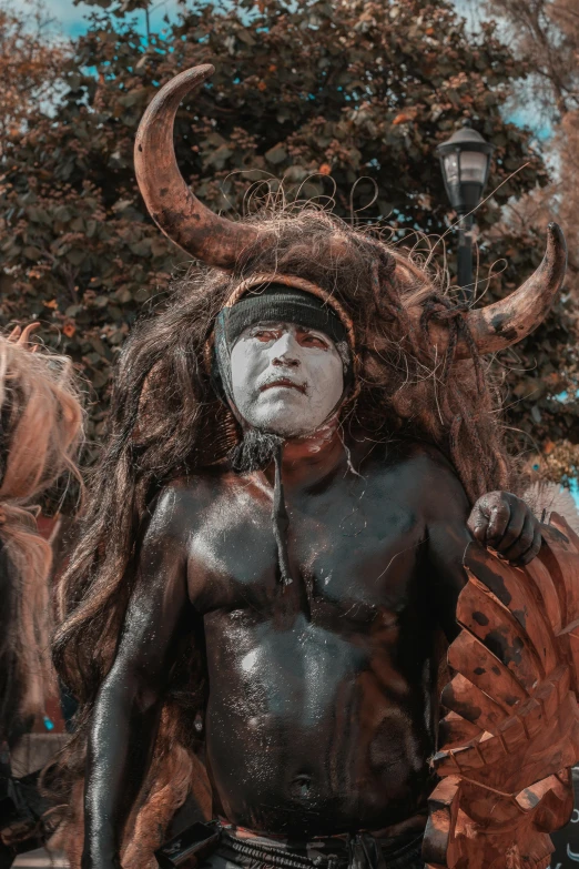 a man dressed up like a demon with horns and beard