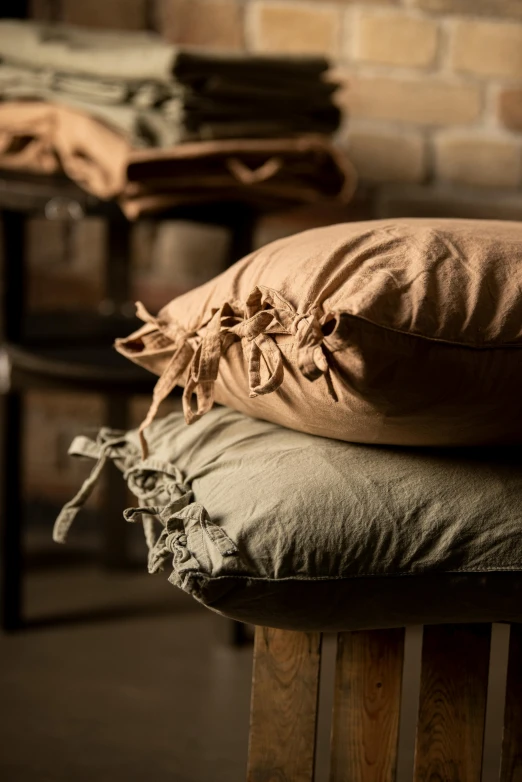 a pillow sits on a chair next to some pillows