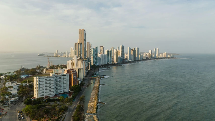 a beach with very tall buildings on the side of the ocean