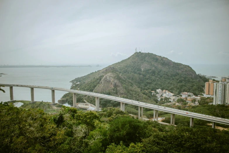 two road bridges over an ocean and a big mountain