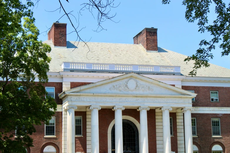 the front view of a building with columns and a round entrance