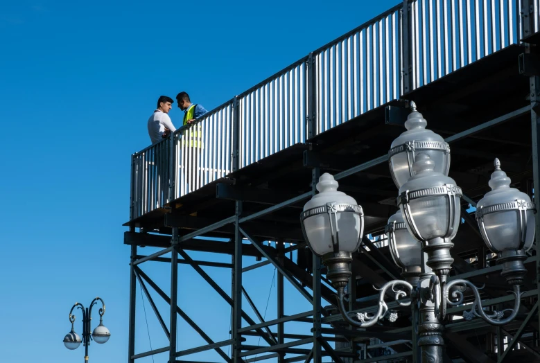 the woman is standing on top of a bridge while taking a po