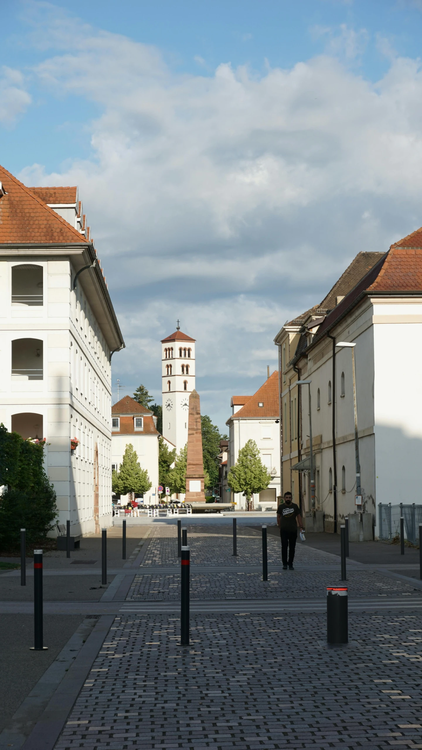 the building in the center is tall and has clocks on each side