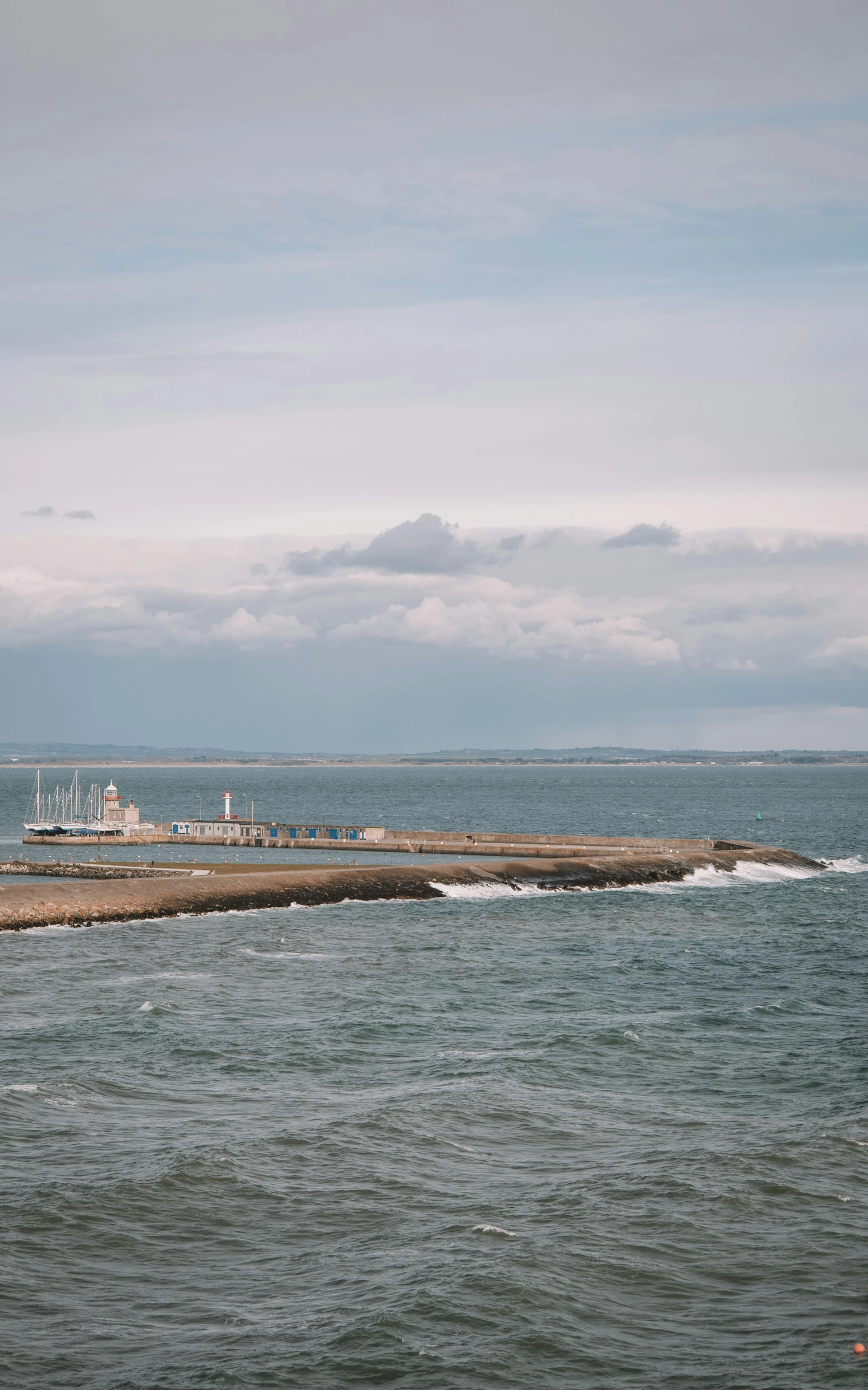 a boat out in the water near a pier